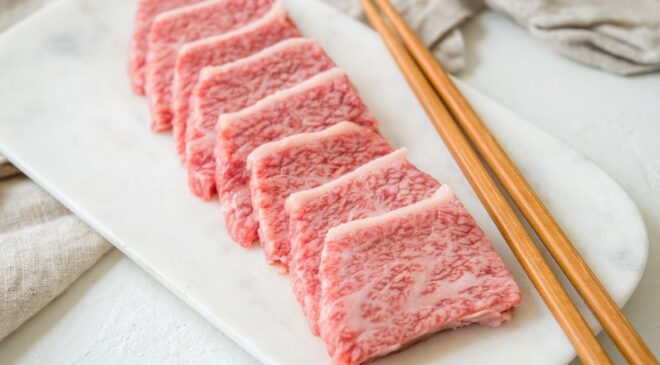 Perfectly pan-seared cubes of A5 Wagyu beef with a caramelized crust and rare center, glistening on a plate