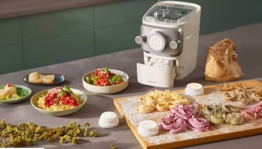 Philips pasta maker producing fresh spaghetti at home kitchen