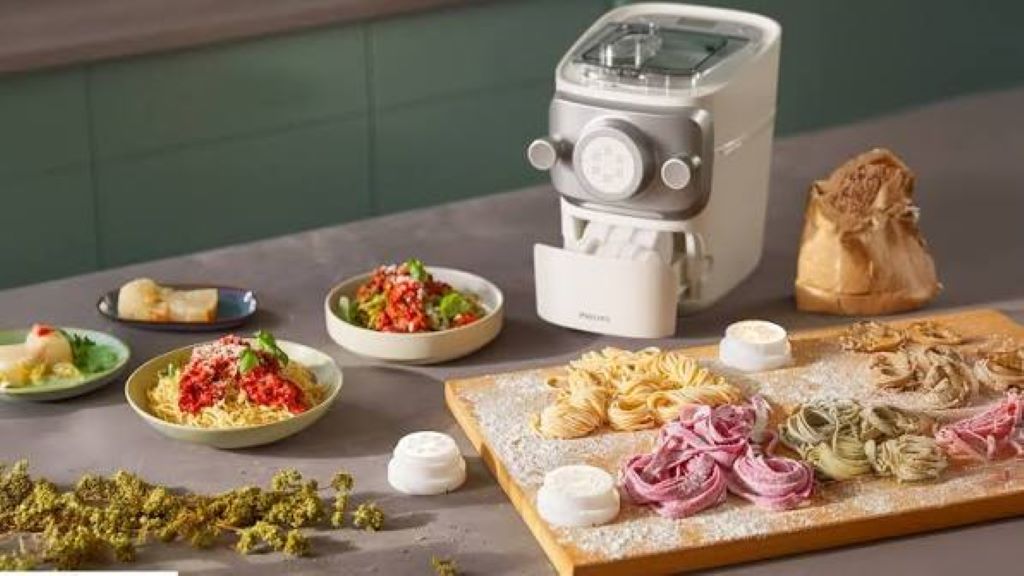 Philips pasta maker producing fresh spaghetti at home kitchen